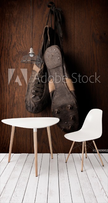 Picture of Old used sports shoes on a rustic wooden wall